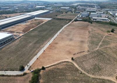 Aerial view of a large vacant land plot showing surrounding industrial area