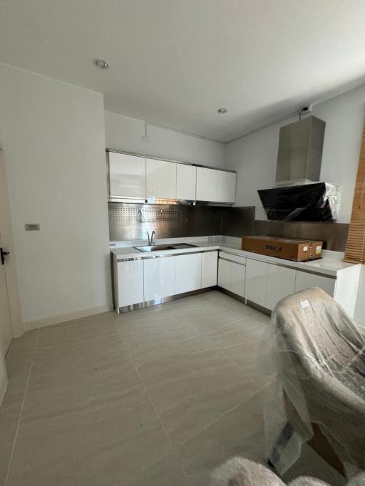 Modern kitchen with stainless steel appliances and white cabinetry