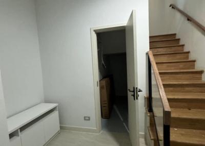 Modern hallway interior with staircase and white walls