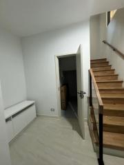Modern hallway interior with staircase and white walls