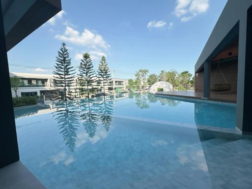 Large swimming pool with clear blue water, surrounded by residential buildings