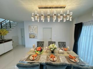 Elegant dining room with modern chandelier and glass table