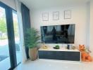 Modern living room interior with large television and decorative plants