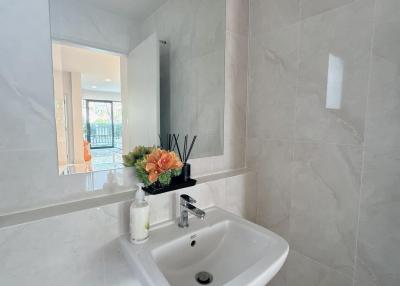 Modern bathroom with wall-mounted sink and elegant decorations