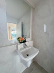Modern bathroom with wall-mounted sink and elegant decorations