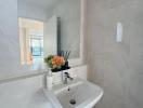 Modern bathroom with wall-mounted sink and elegant decorations