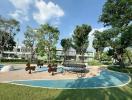 Modern playground in a residential outdoor area with lush greenery and contemporary homes in the background