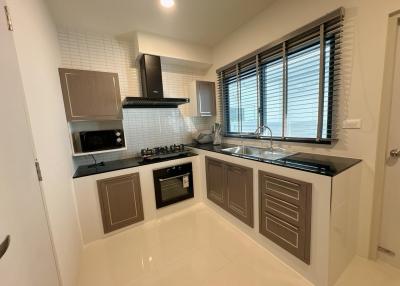 Modern kitchen with stainless steel appliances and white tiles