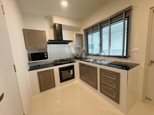 Modern kitchen with stainless steel appliances and white tiles