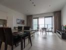 Spacious living room with ocean view, dining area, and balcony access