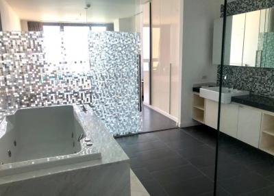 Modern bathroom interior with mosaic tiles and large bathtub