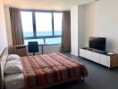 Spacious bedroom with a sea view, large bed, and modern furnishings