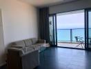 Bright and spacious seaside living room with floor-to-ceiling windows and ocean view