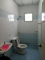 Compact bathroom with tiled walls and light blue flooring