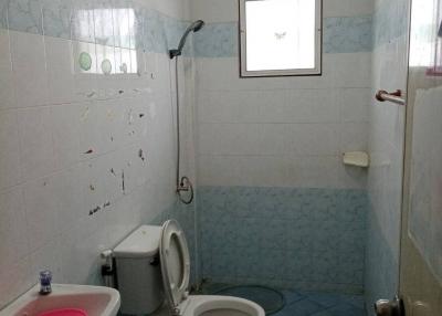 Compact bathroom with tiled walls and light blue flooring