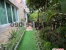 Paved pathway in the outdoor garden area of a home with lush greenery