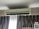 Air conditioner above curtains in a nondescript room