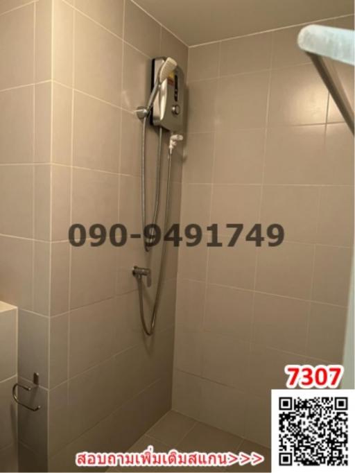 Modern tiled bathroom with wall-mounted shower