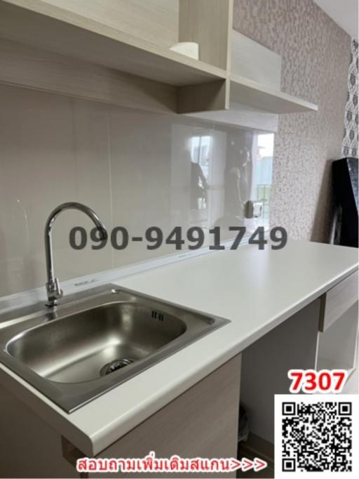 Modern kitchen interior with stainless steel sink and white countertops