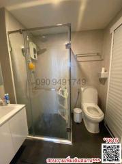 Modern bathroom with glass shower enclosure and white toilet