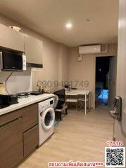 Compact kitchen space with modern appliances and laundry setup