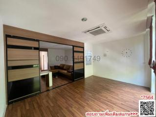 Spacious bedroom with hardwood floors, large sliding wardrobe, and air conditioning