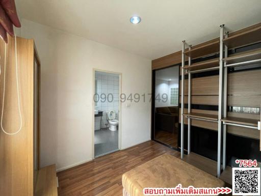 Spacious bedroom with hardwood flooring and built-in shelving