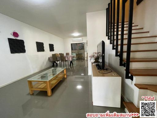 Spacious and modern living room with staircase and dining area