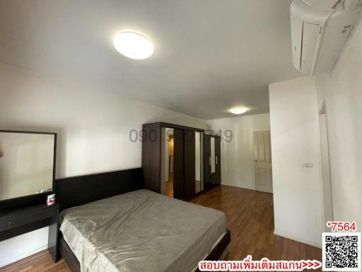 Spacious bedroom with air conditioning and hardwood floor