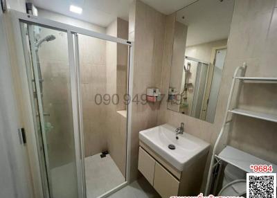 Modern bathroom interior with glass shower and white basin