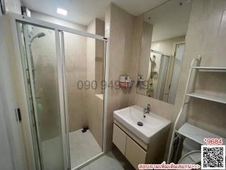 Modern bathroom interior with glass shower and white basin