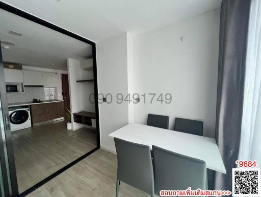 Compact dining table in a small apartment with open kitchen and laundry area
