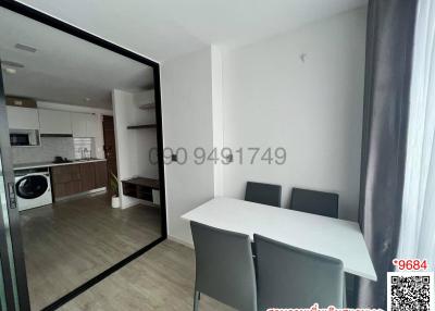 Compact dining table in a small apartment with open kitchen and laundry area