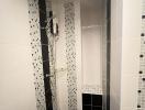 Narrow tiled bathroom with walk-in shower