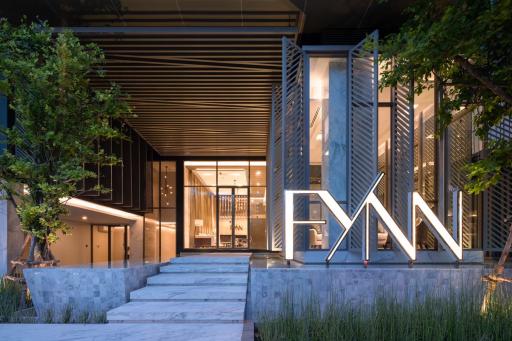 Modern building exterior at dusk with illuminated entrance and stylish design