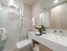 Modern bathroom with glass shower and well-lit vanity area