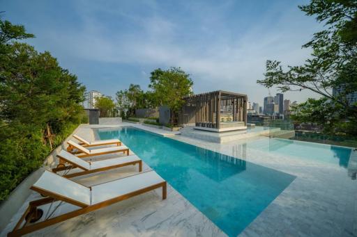 Luxurious rooftop pool with city skyline view and relaxation area
