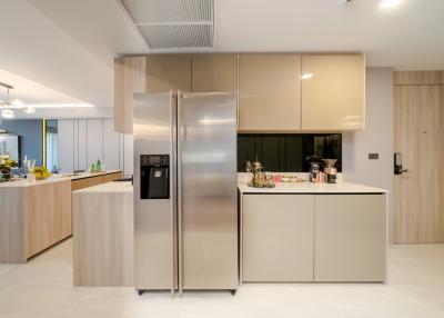 Modern spacious kitchen with large refrigerator and central island