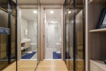 Modern bathroom interior with glass shower and mirrored cabinets