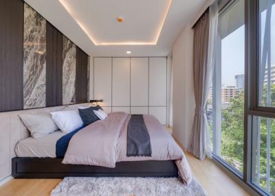 Modern bedroom with large windows and stylish decor