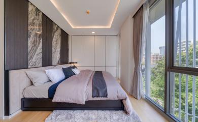 Modern bedroom with large windows and stylish decor
