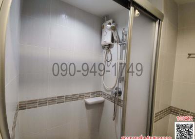 Modern bathroom interior with glass shower and white ceramic fixtures