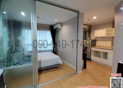 Modern bedroom with sliding glass door and compact workspace
