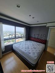 Spacious bedroom with large window and city view