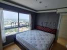 Spacious bedroom with large window and city view