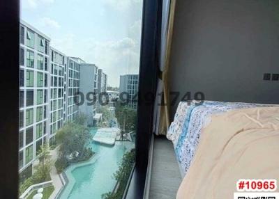 Bedroom with a view of the swimming pool and apartment complex