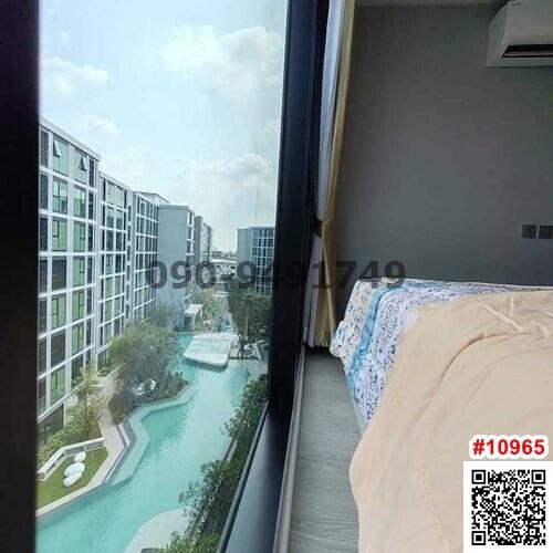 Bedroom with a view of the swimming pool and apartment complex