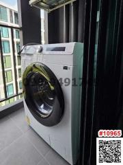 Washing machine on modern apartment balcony with city view