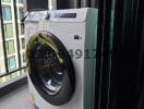 Washing machine on modern apartment balcony with city view