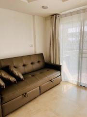 Modern living room with leather sofa and large window